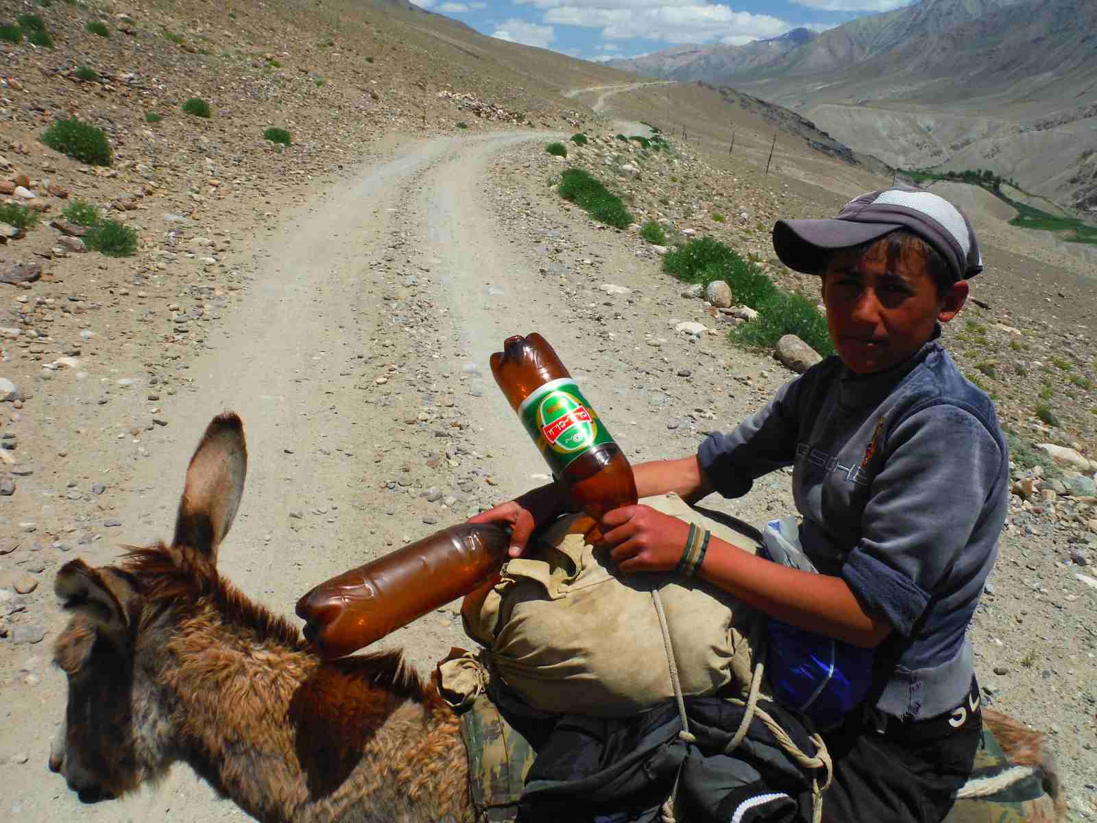 the kumis king on his mule riding the pamir highway