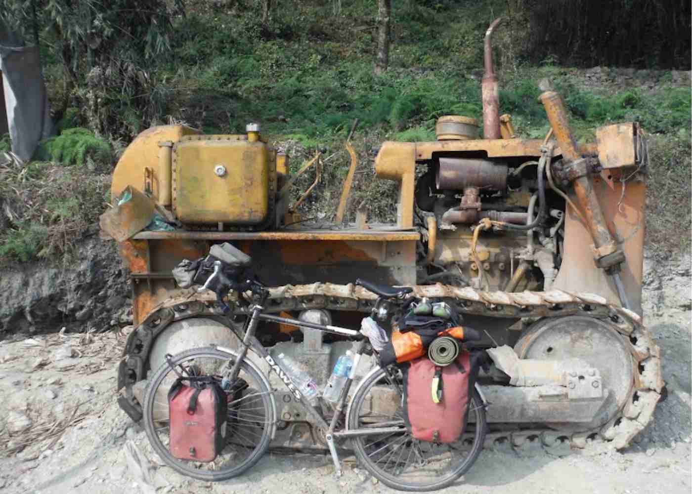 touring bike rests with an old fashioned digger