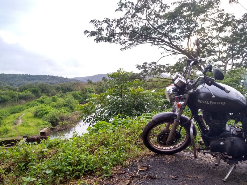 royal enfield by a river in goa 