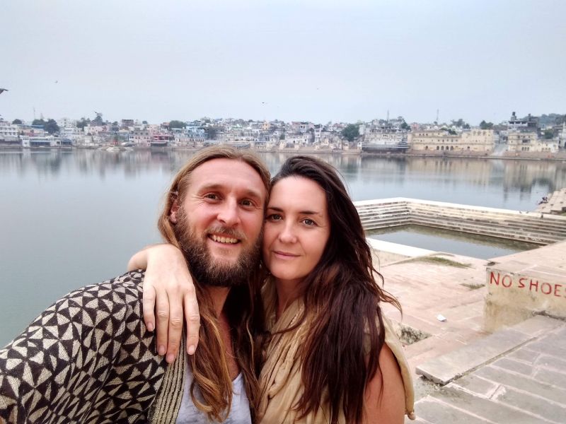 charlie and JT in Pushkar a young couple embrace at pushkar sarovar in india